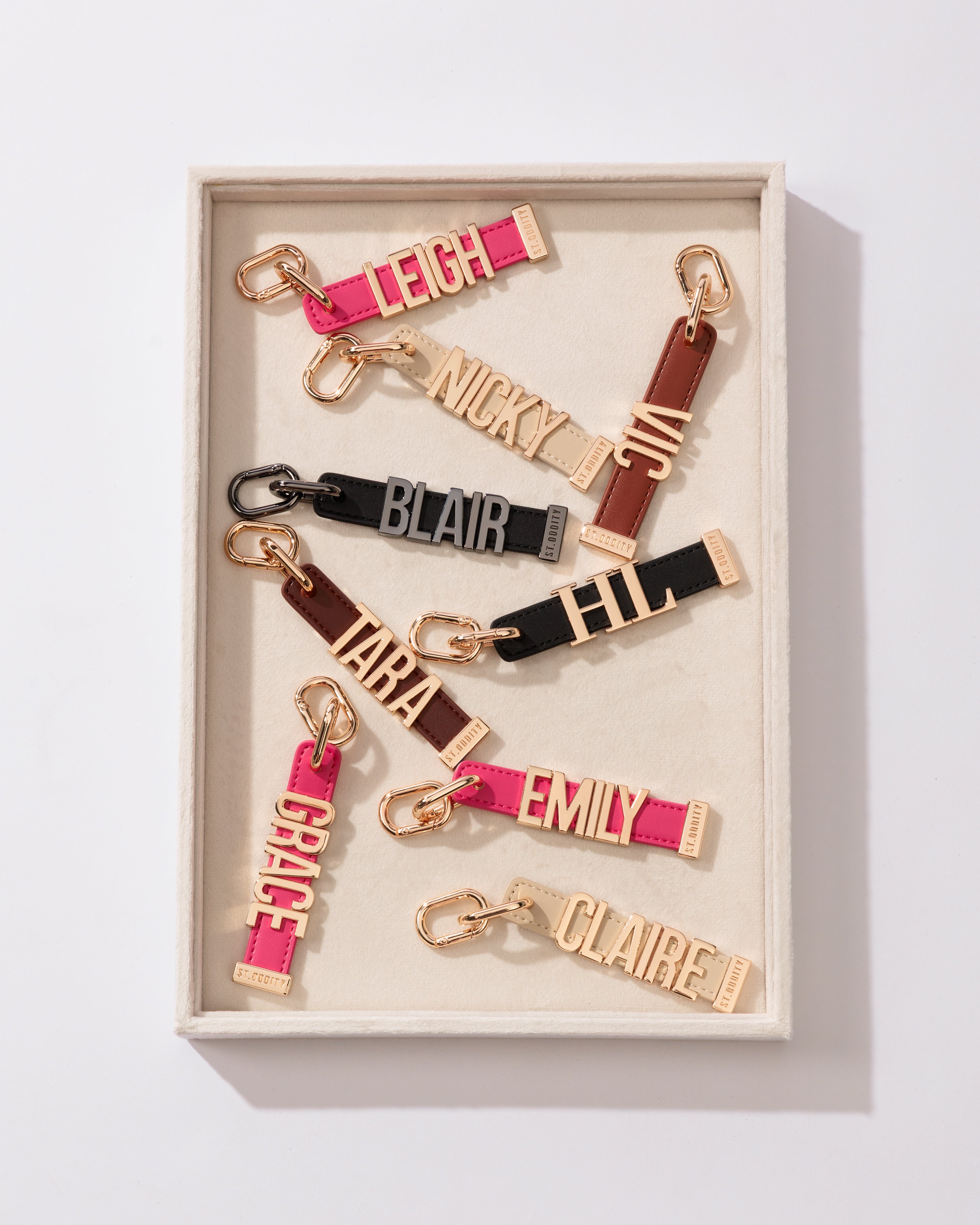 Set of personalized keychains with names in a box on a light background