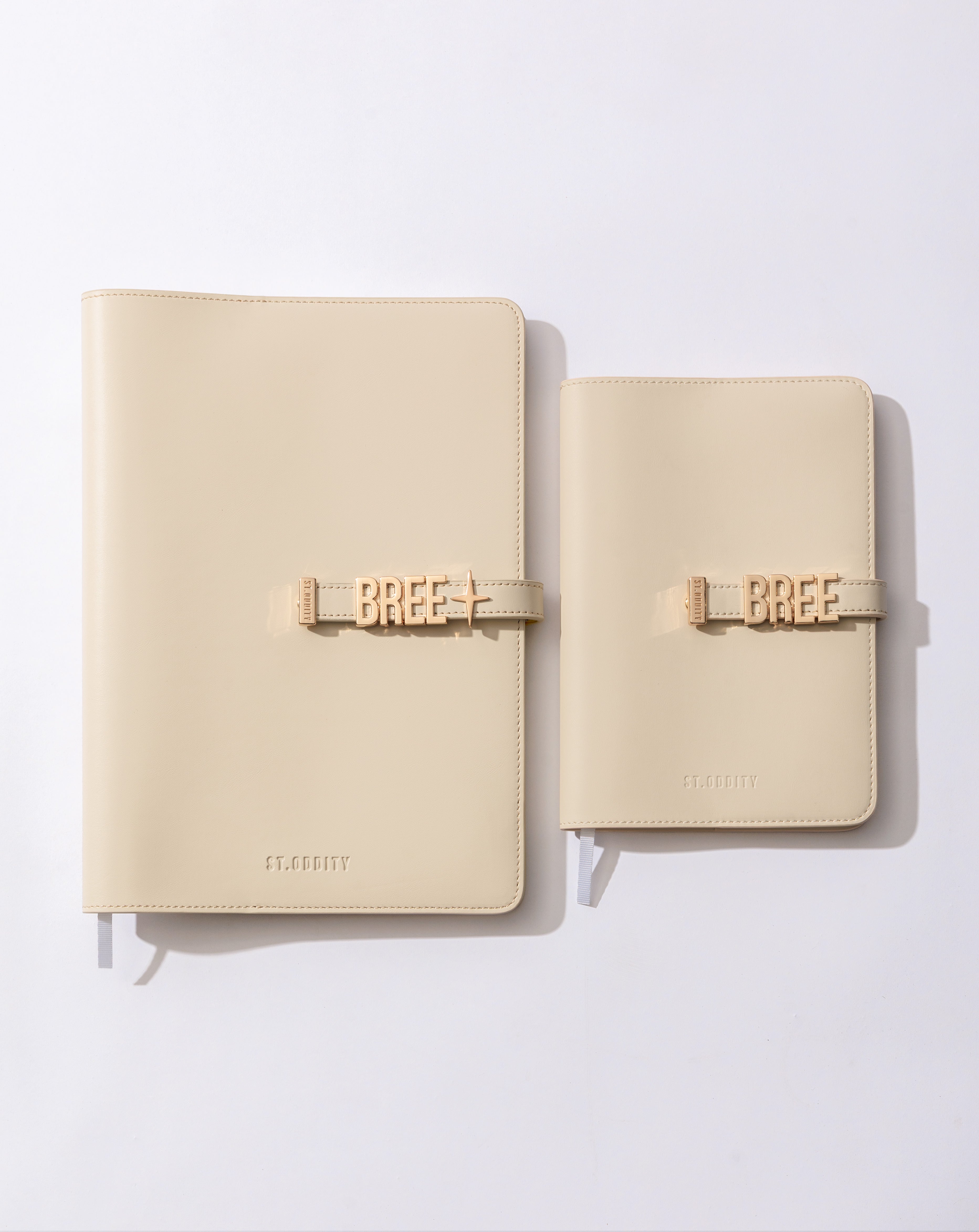Comparison of A4 and A5 sized notebooks in off white on a white background.