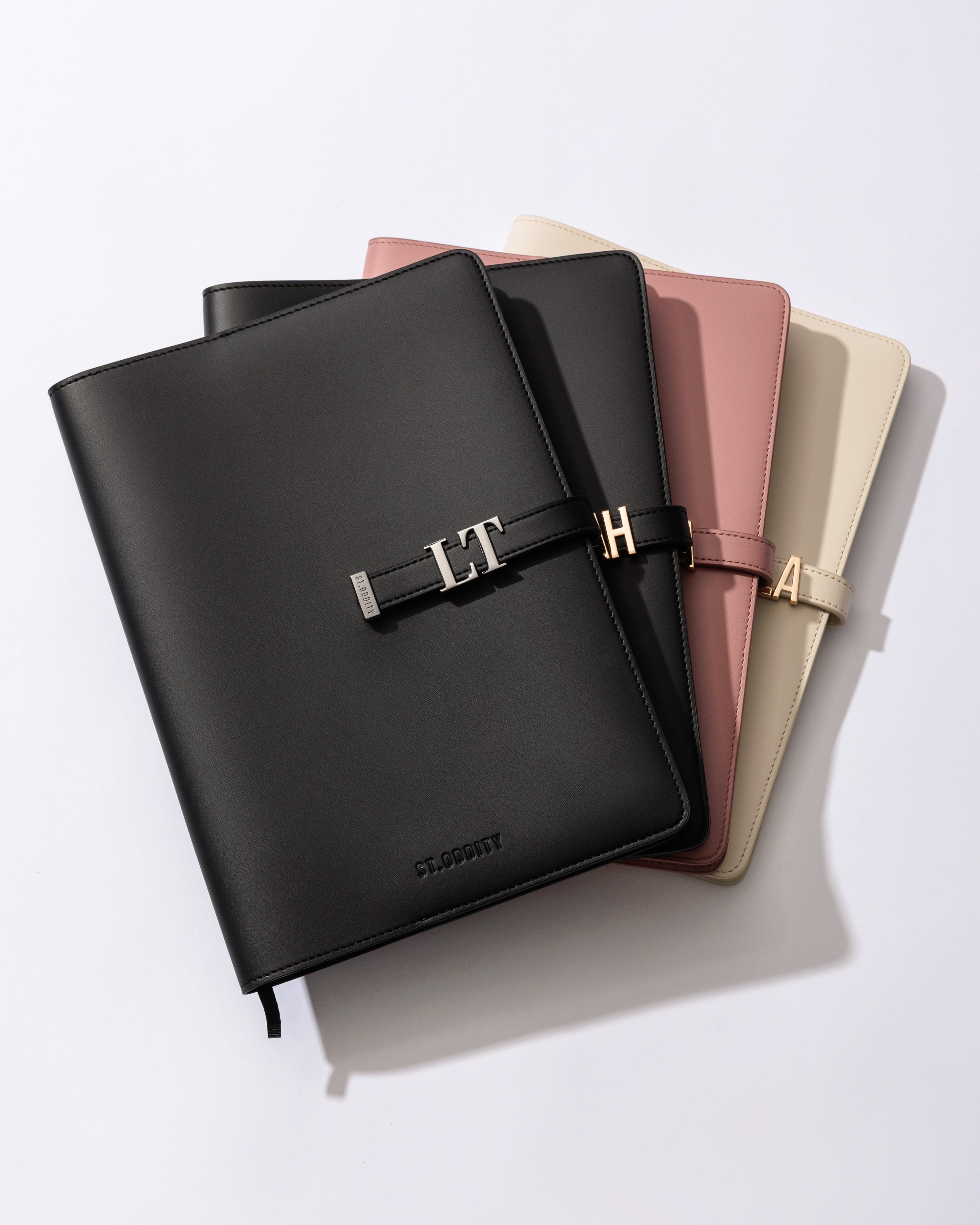 Comparison of personalised A4 Notebooks in Black/Gunmetal, Black/Gold, Blush and Off White.