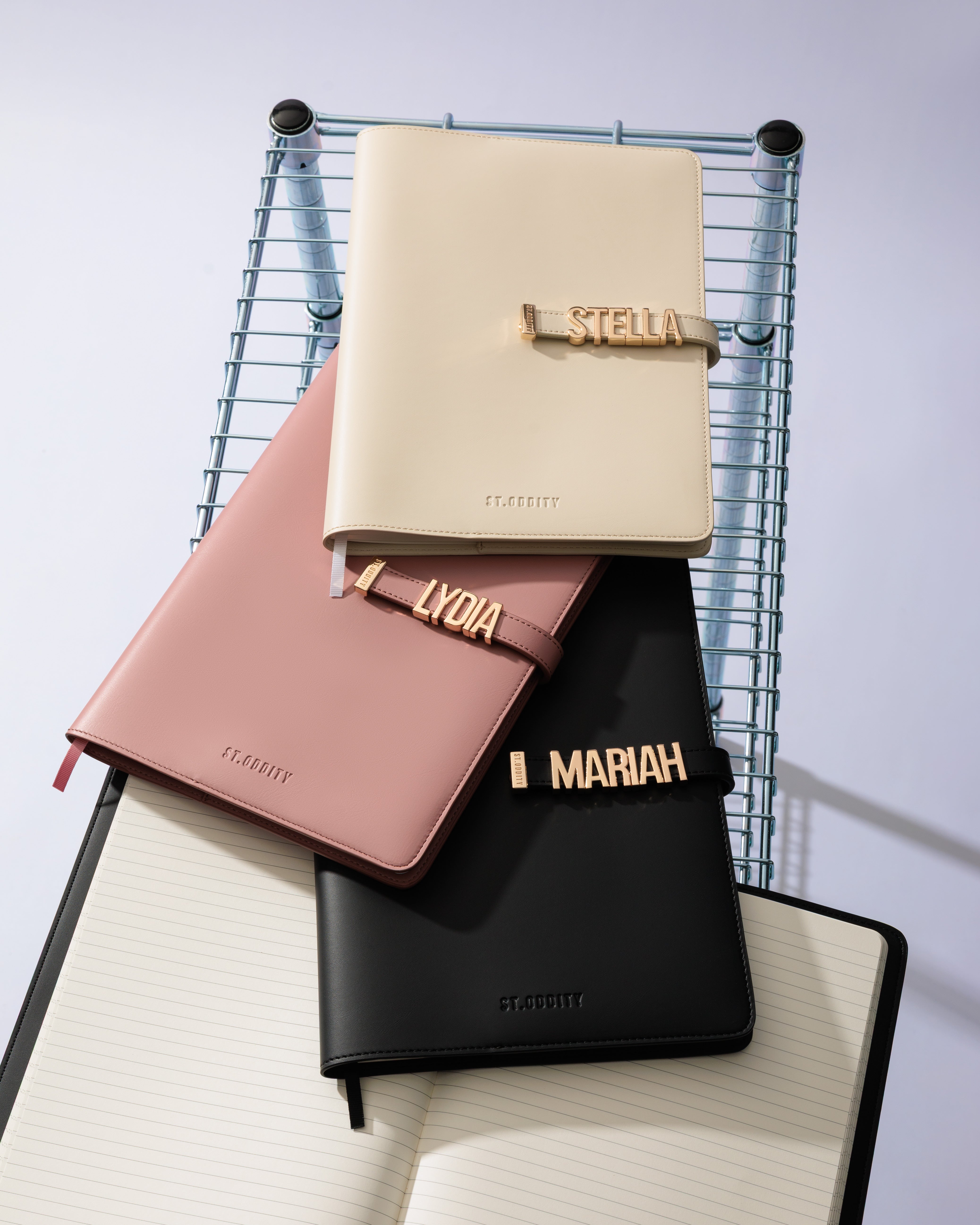 Comparison of personalised A4 Notebooks in Black/Gunmetal, Black/Gold, Blush and Off White.