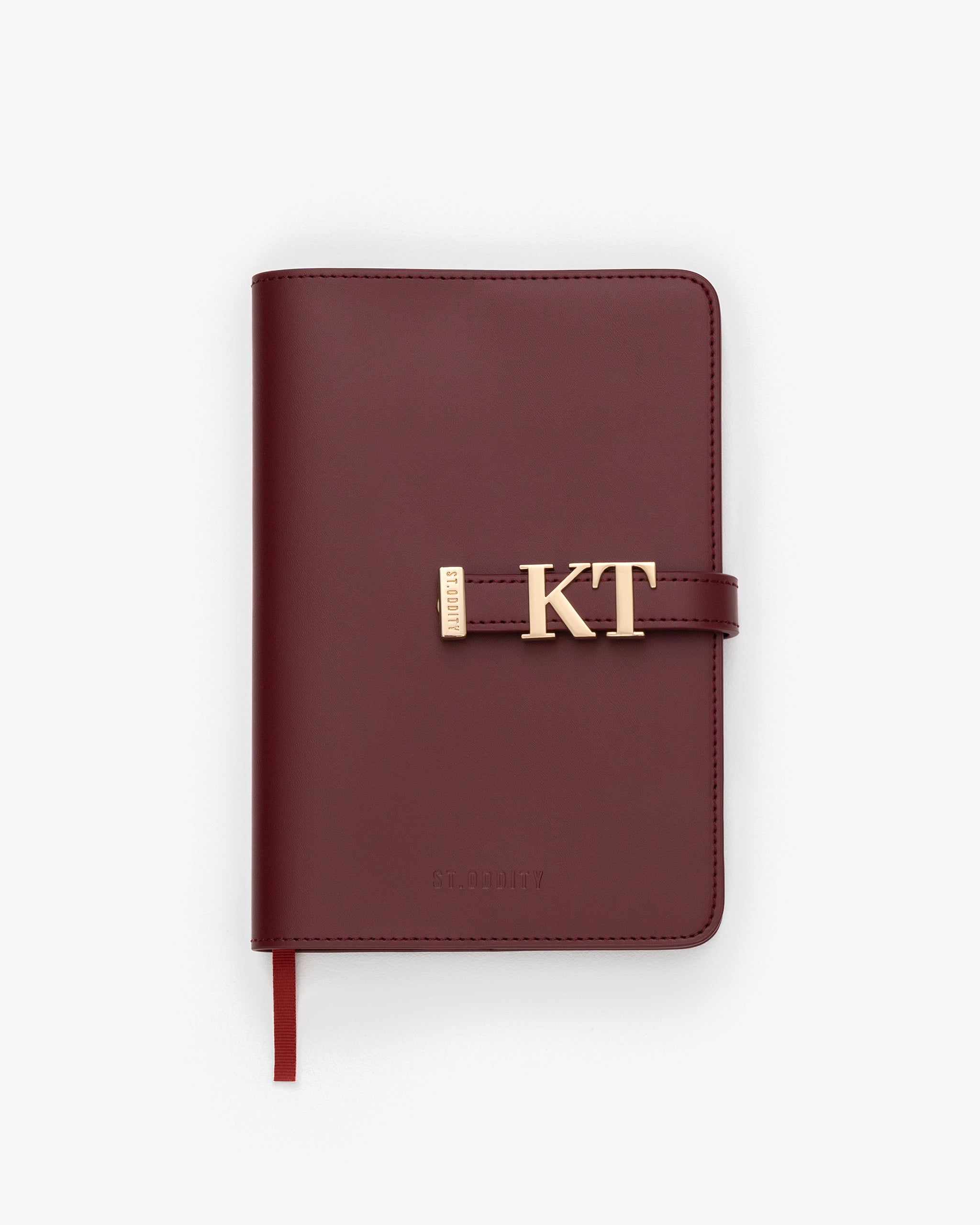 Oxblood notebook with gold personalisation 'KT' on a white background