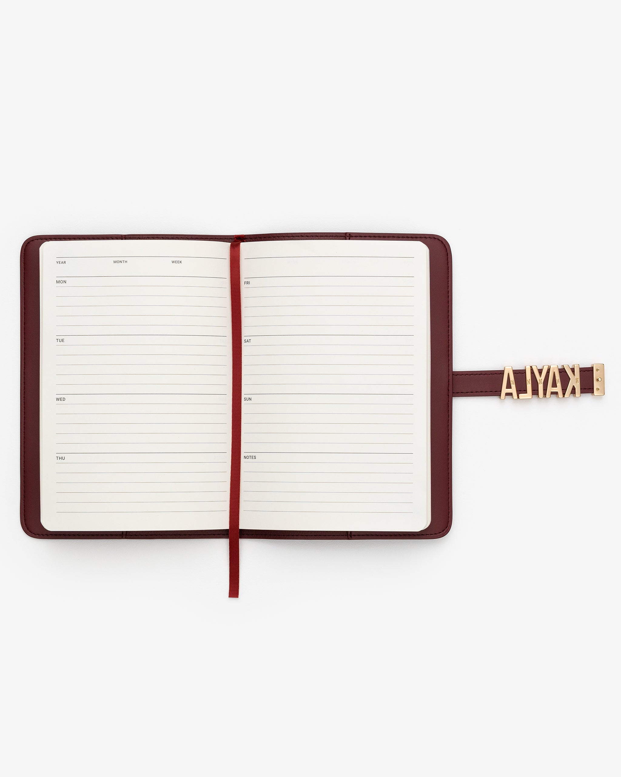 Open notebook with a weekly planner on a white background