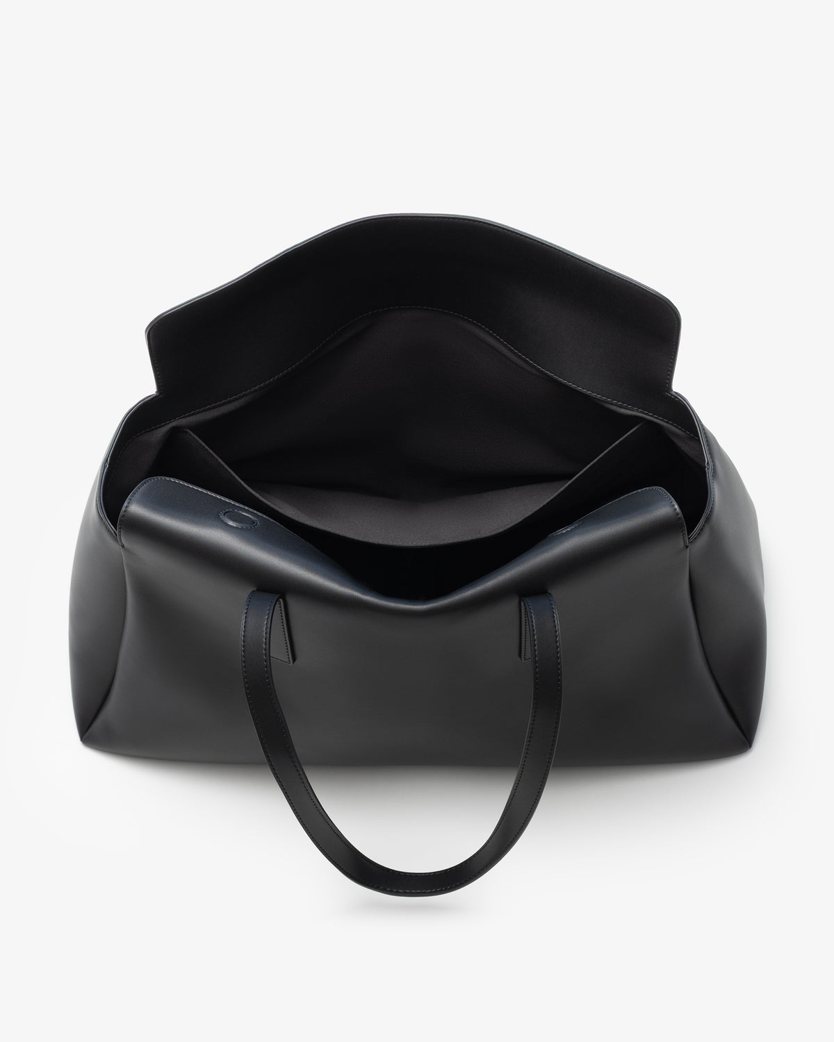 A black leather tote bag shown from a top-down view, open to reveal its interior, on a clean white background.