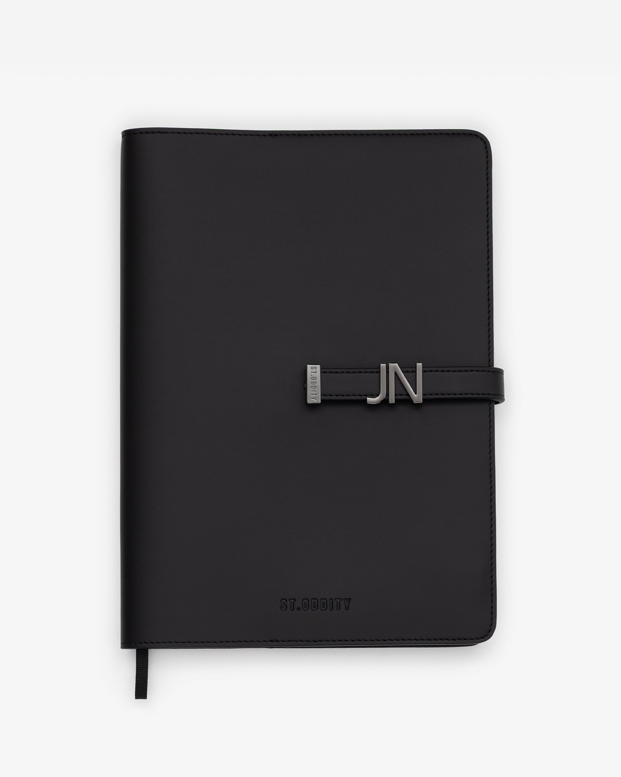 Black/Gunmetal A4 Notebook with 'JN' gold personalisation on a white background.