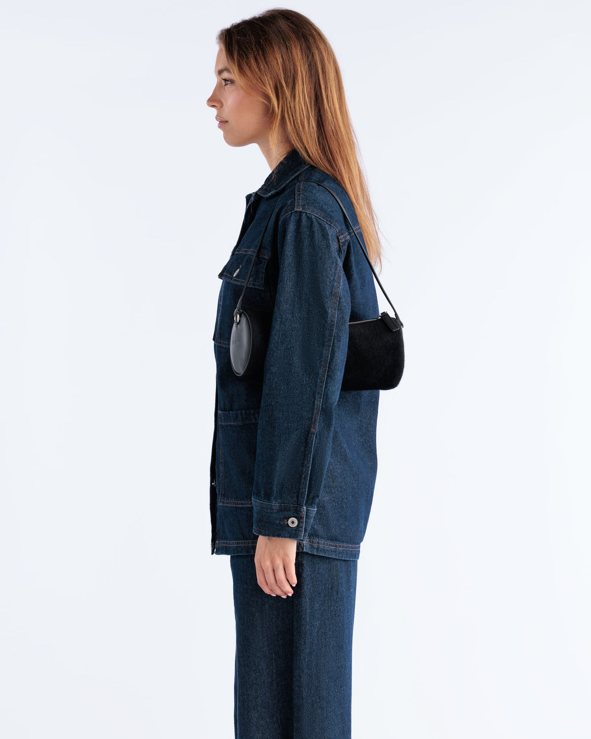 Model carrying the Barrel Bag in Black pony hair