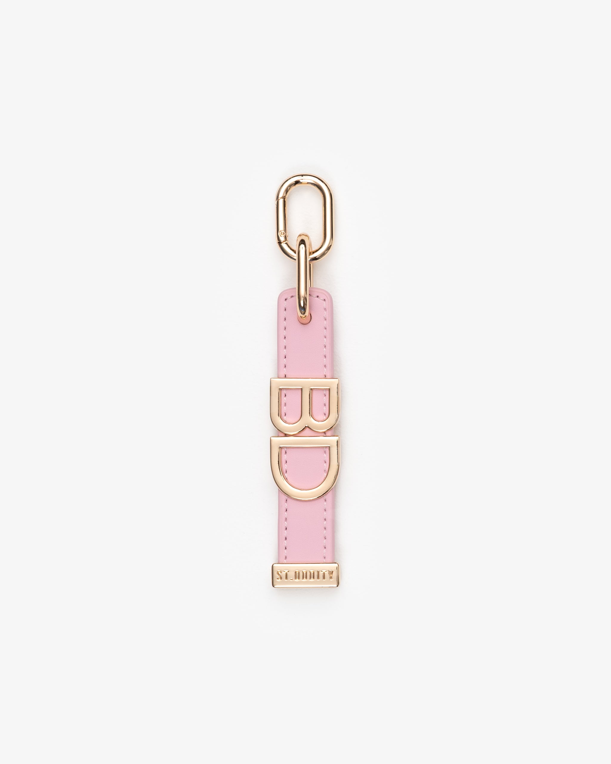 Pink keychain with gold accents on a white background