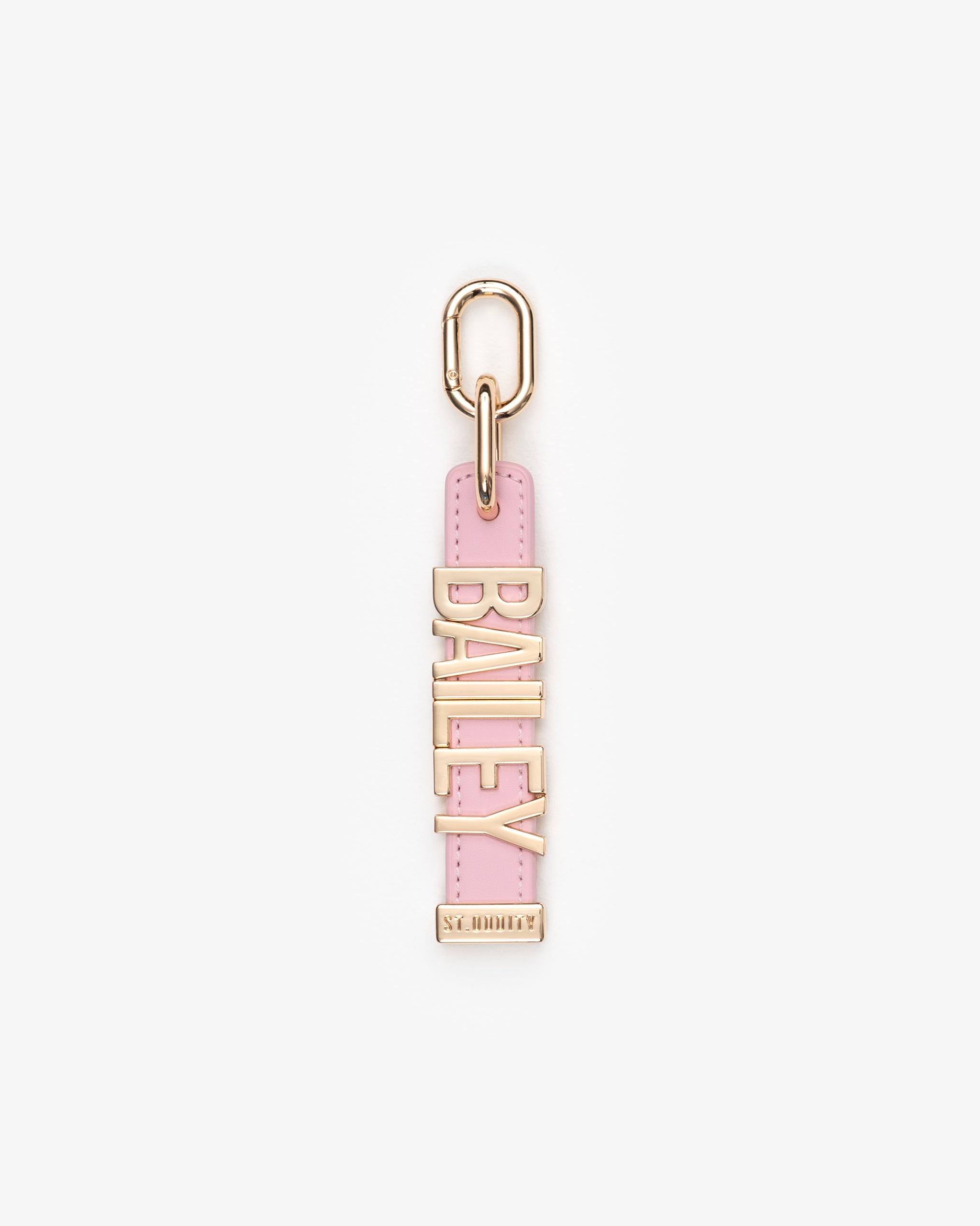 Pink and gold keychain with 'BAILEY' on a white background