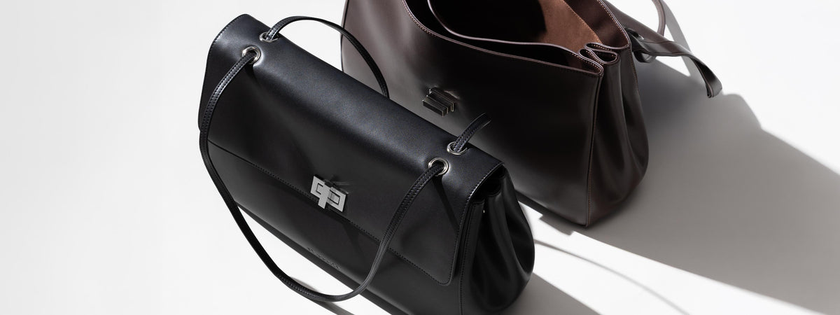 Commute shoulder bag in black and brown