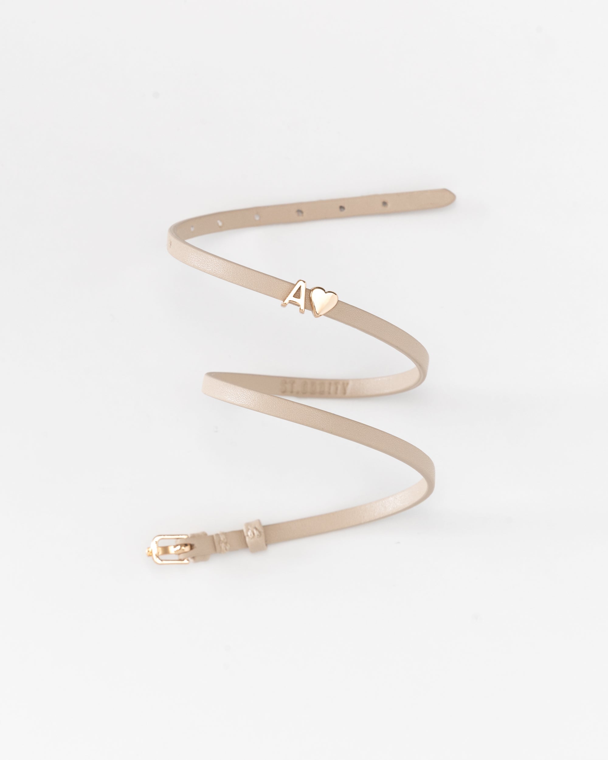 Beige vegan leather bracelet with 'A' in gold letter personalisation on a white background.