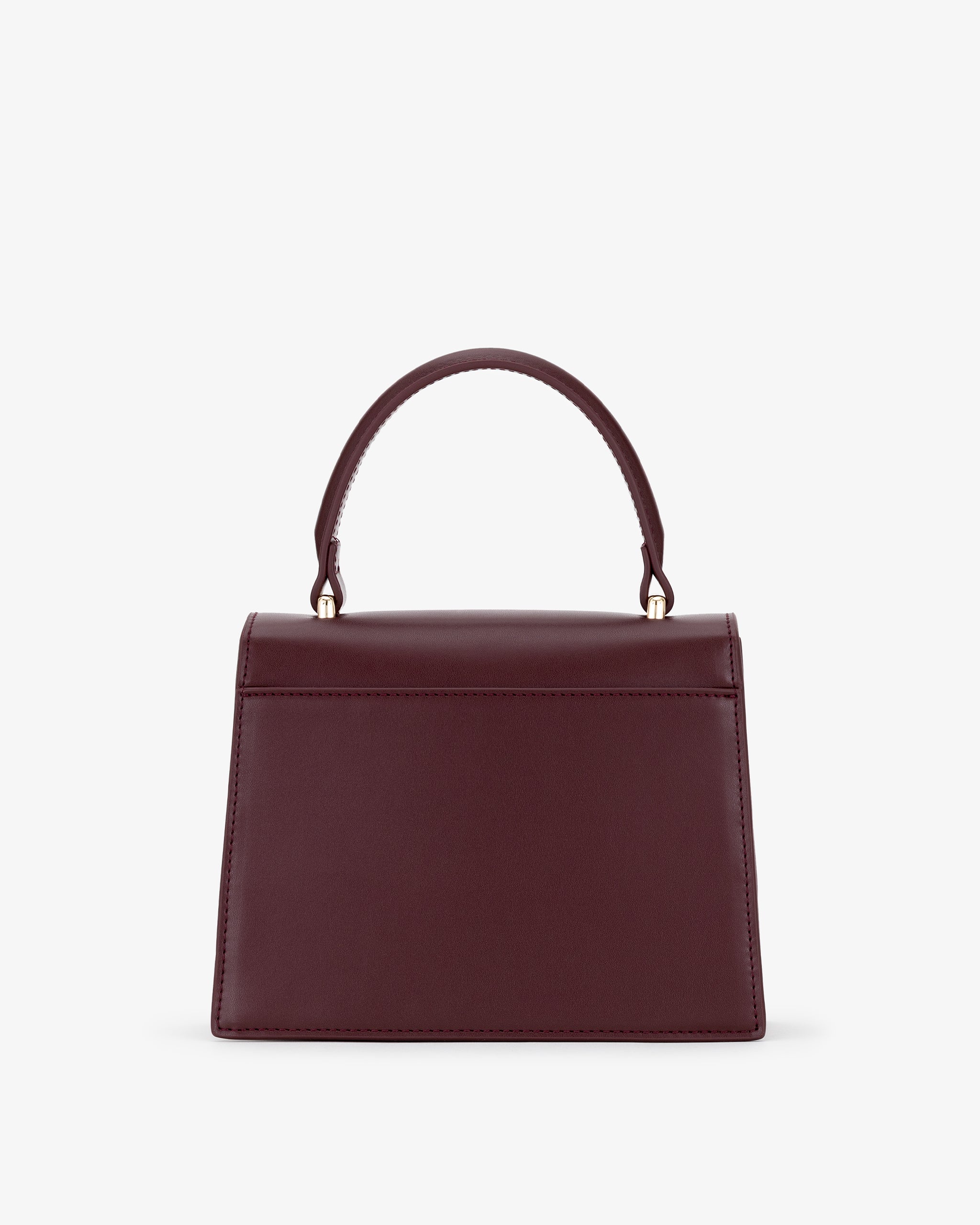 Oxblood handbag with a handle on a white background