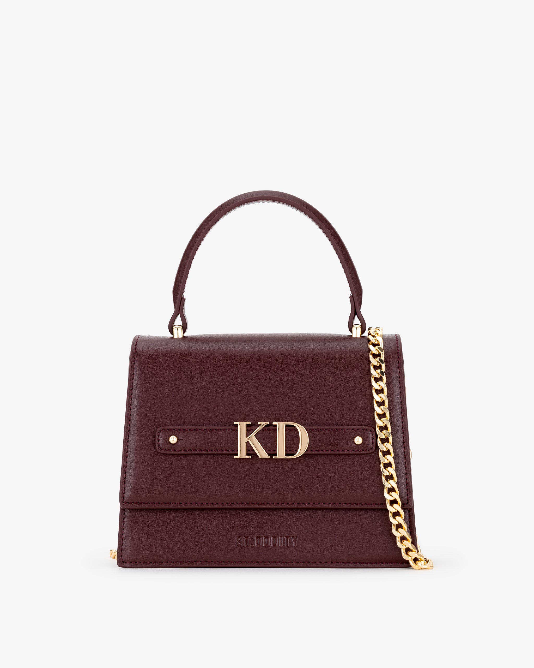Oxblood handbag with gold personalisation 'KD' on a white background