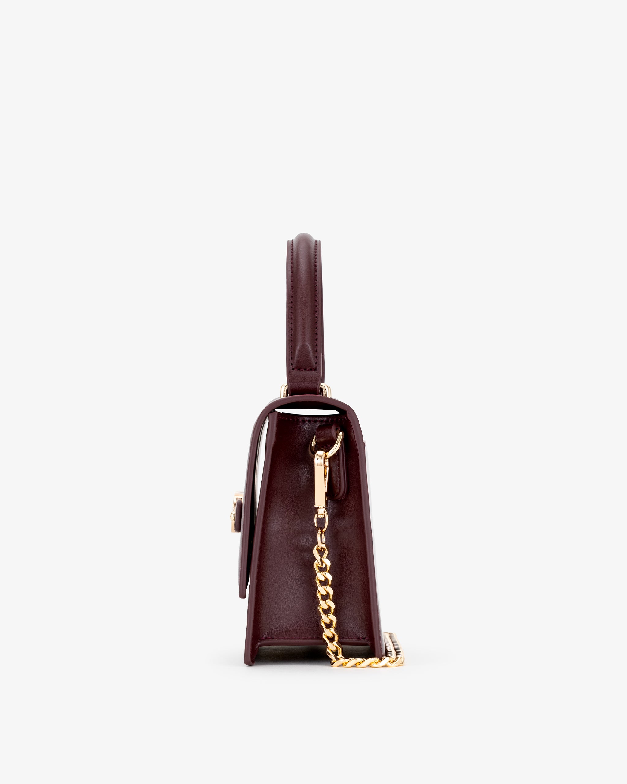 Oxblood handbag with a gold chain on a white background
