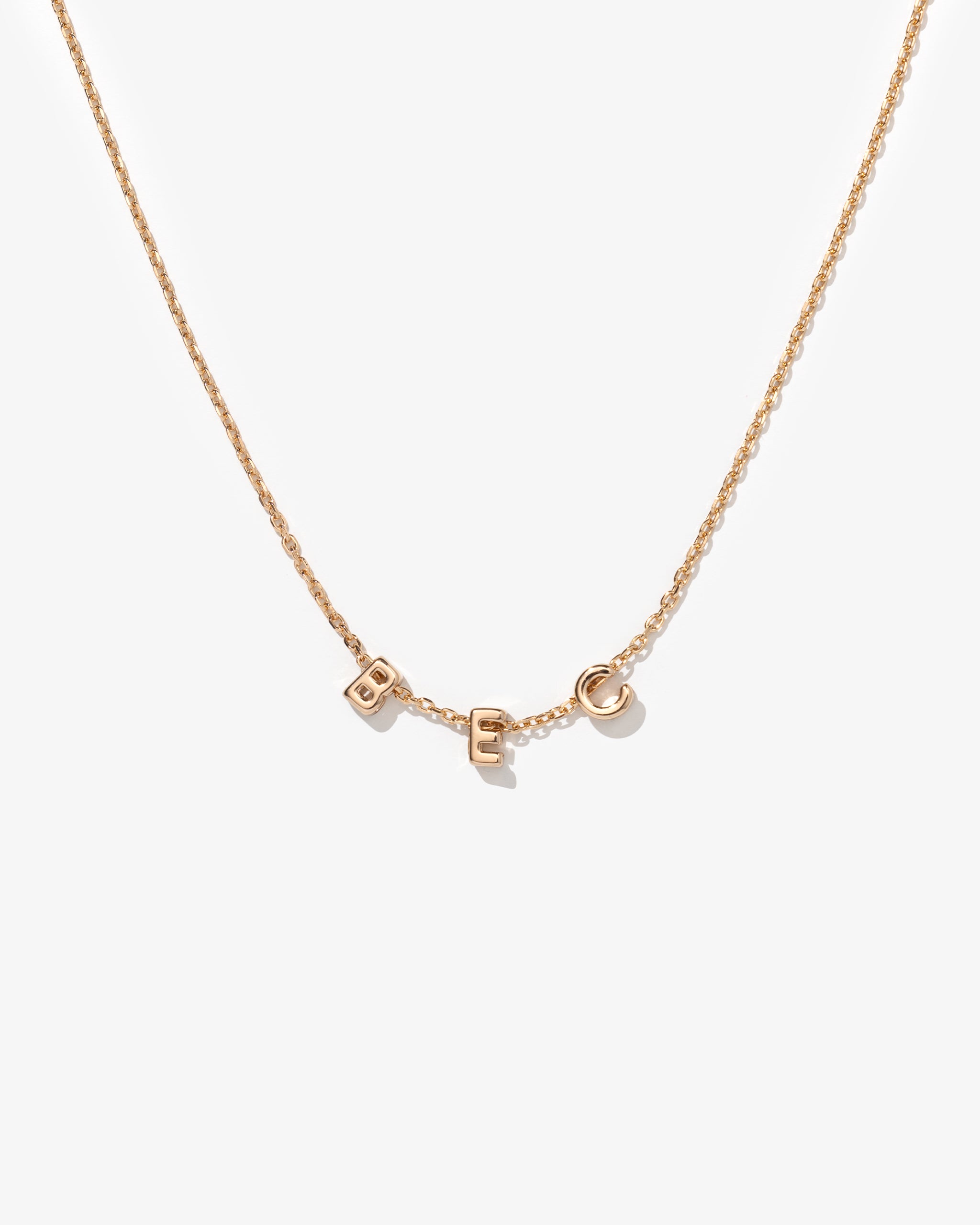 Gold fine chain necklace with 'BEC' personalised on it