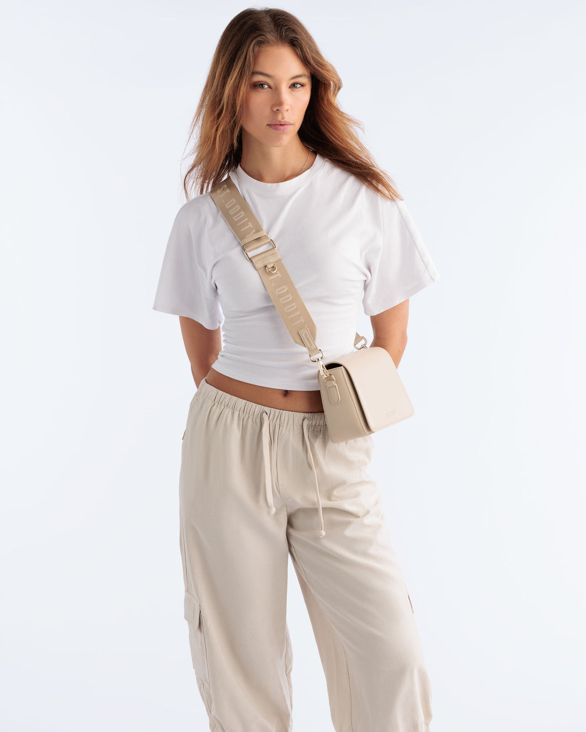 Model wearing the Street Crossbody Bag in Light Sand