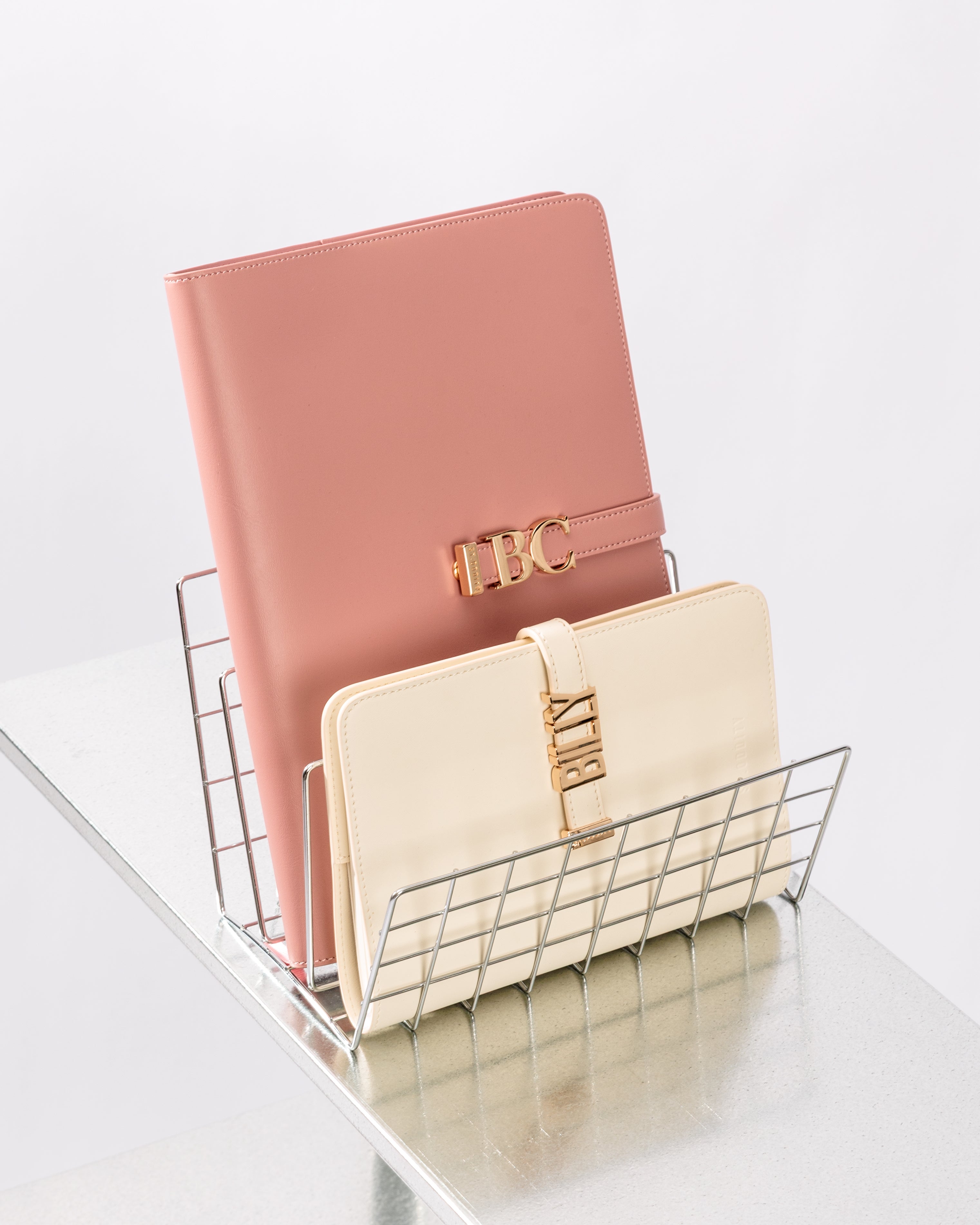 Comparsion of A4 and A5 sized notebooks in Blush and Off White with 'BC' and 'Billy' personalisation.