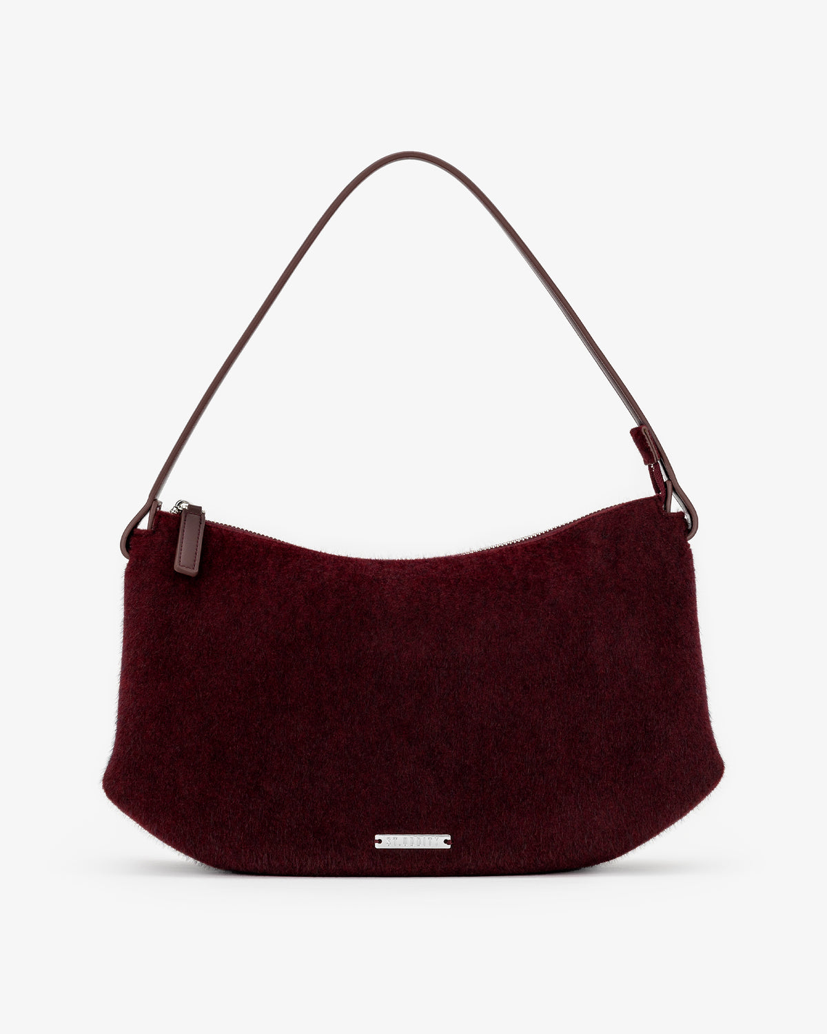 A burgundy pony hair shoulder bag with a dark brown leather strap and a small silver metal plaque on the front, set against a plain white background.