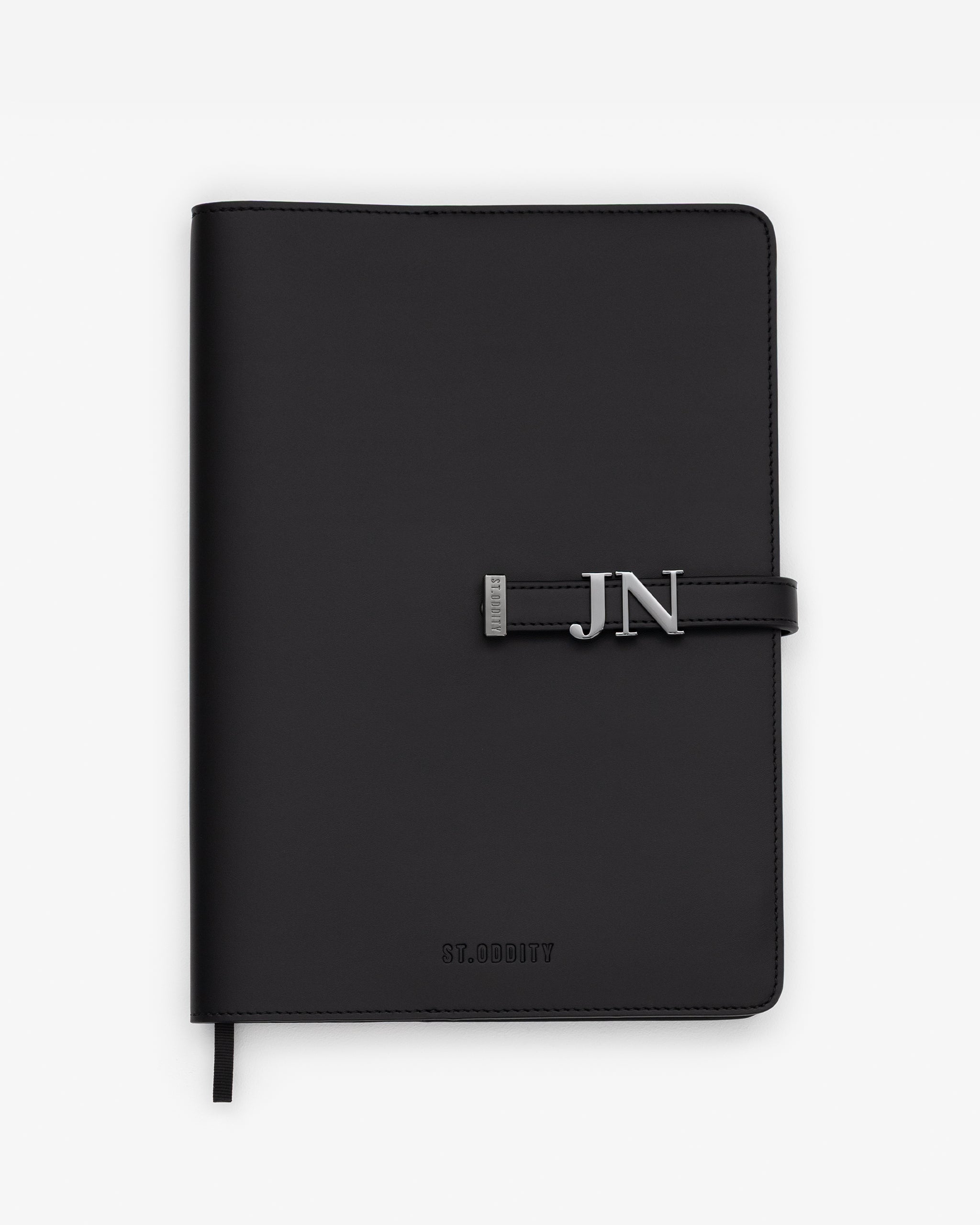 Black/Gunmetal A4 Notebook with 'JN' gold personalisation on a white background.