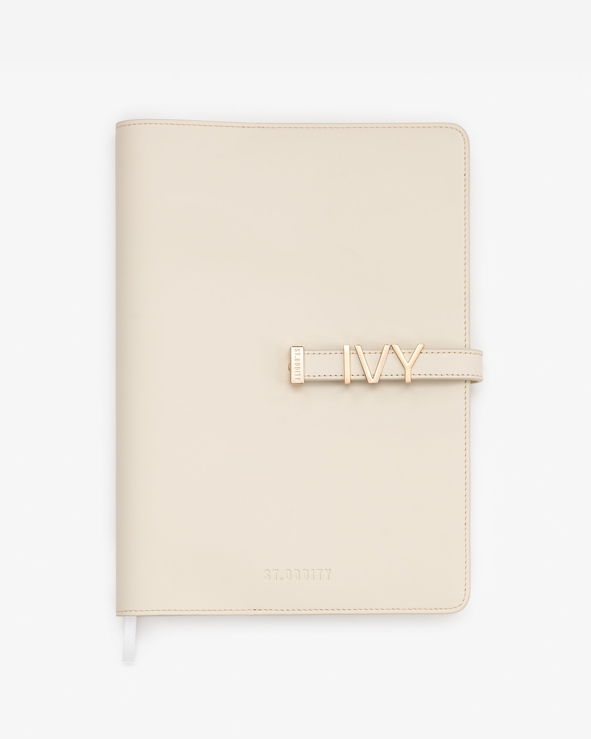 Off white A4 Notebook personalised with 'IVY' in large gold hardware on a white background.