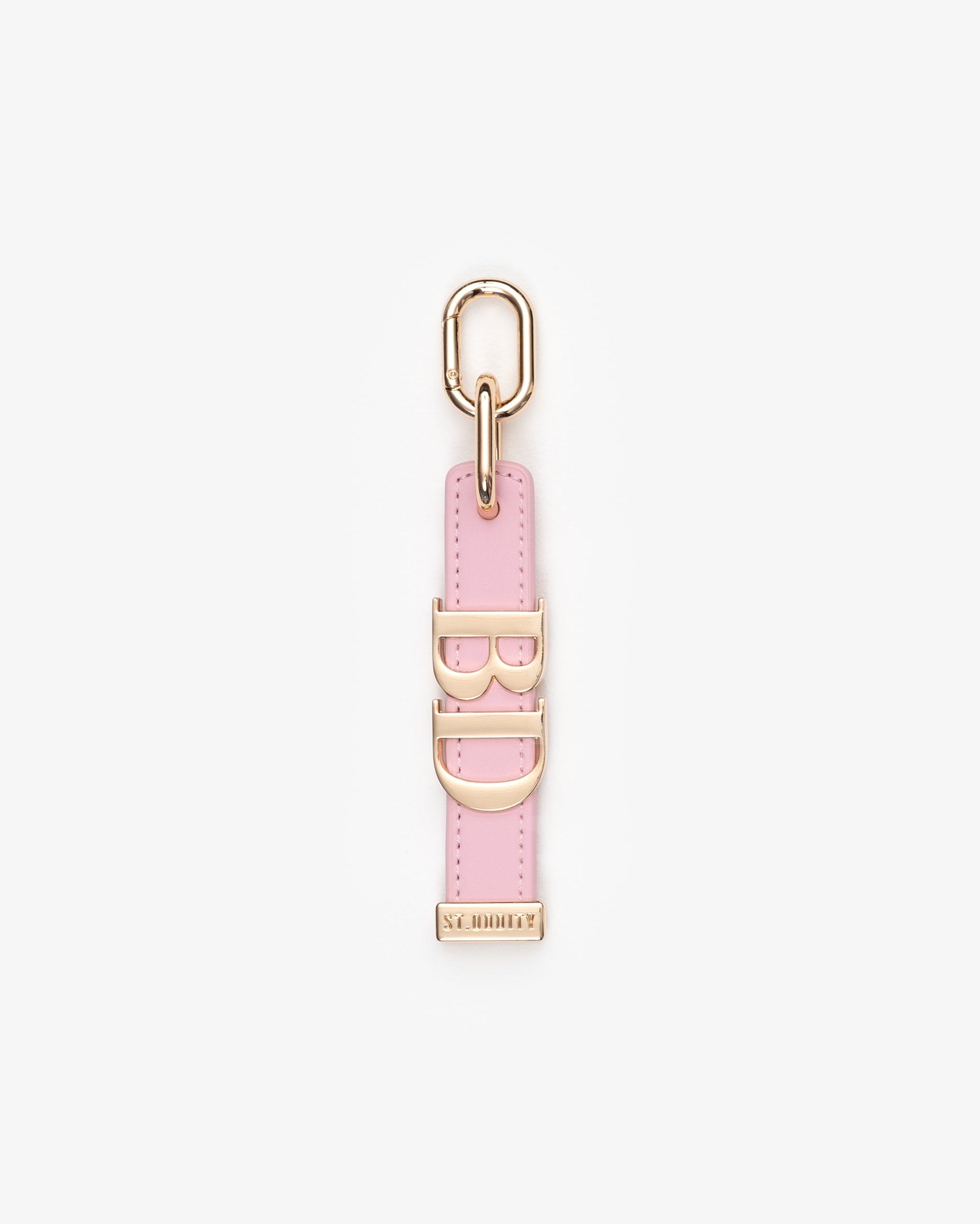 Pink keychain with gold accents on a white background
