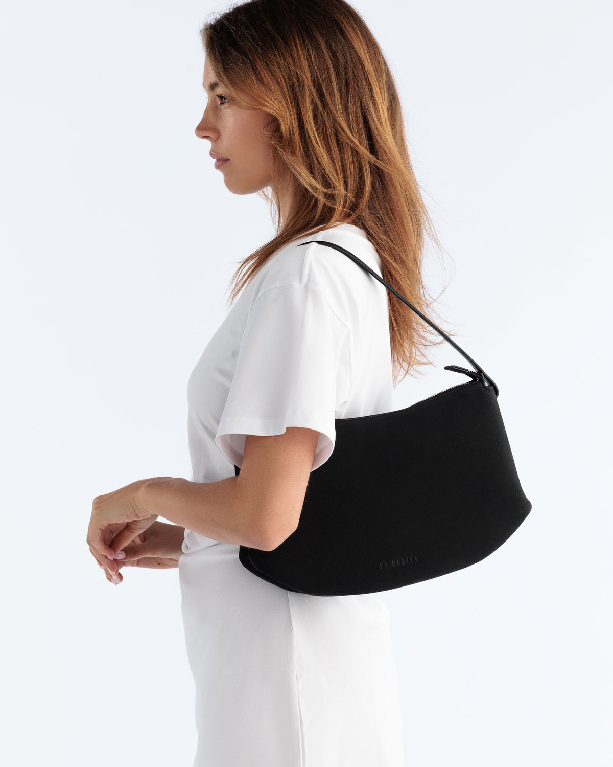 Model carrying the Detour Shoulder Bag in Black