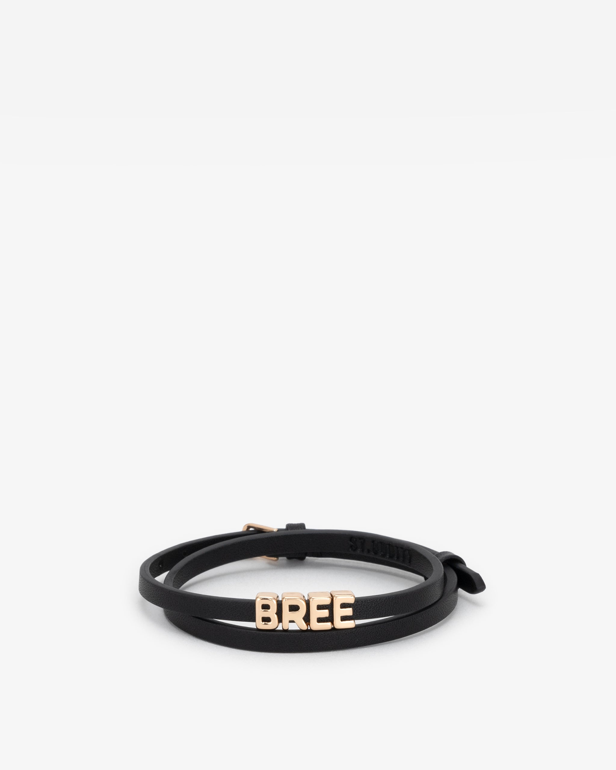Black vegan leather bracelet with 'BREE' in gold letter personalisation on a white background.