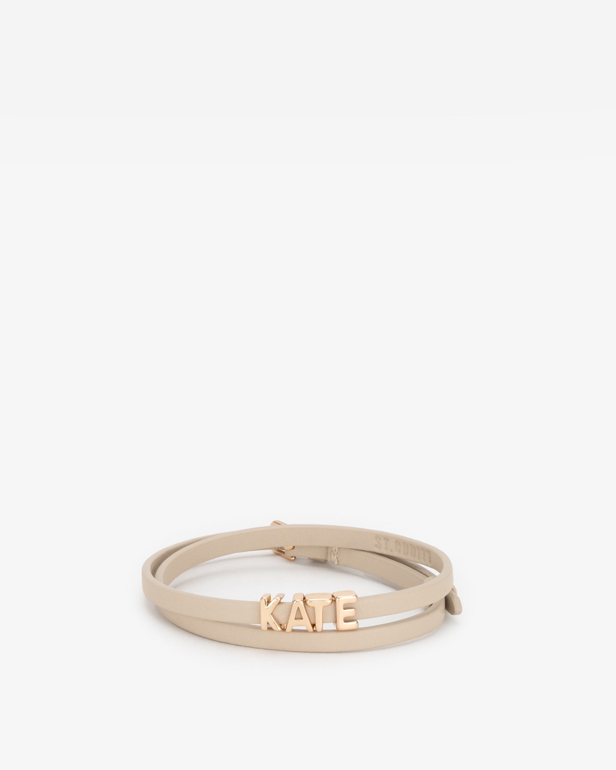 Beige vegan leather bracelet with 'KATE' in gold letter personalisation on a white background.