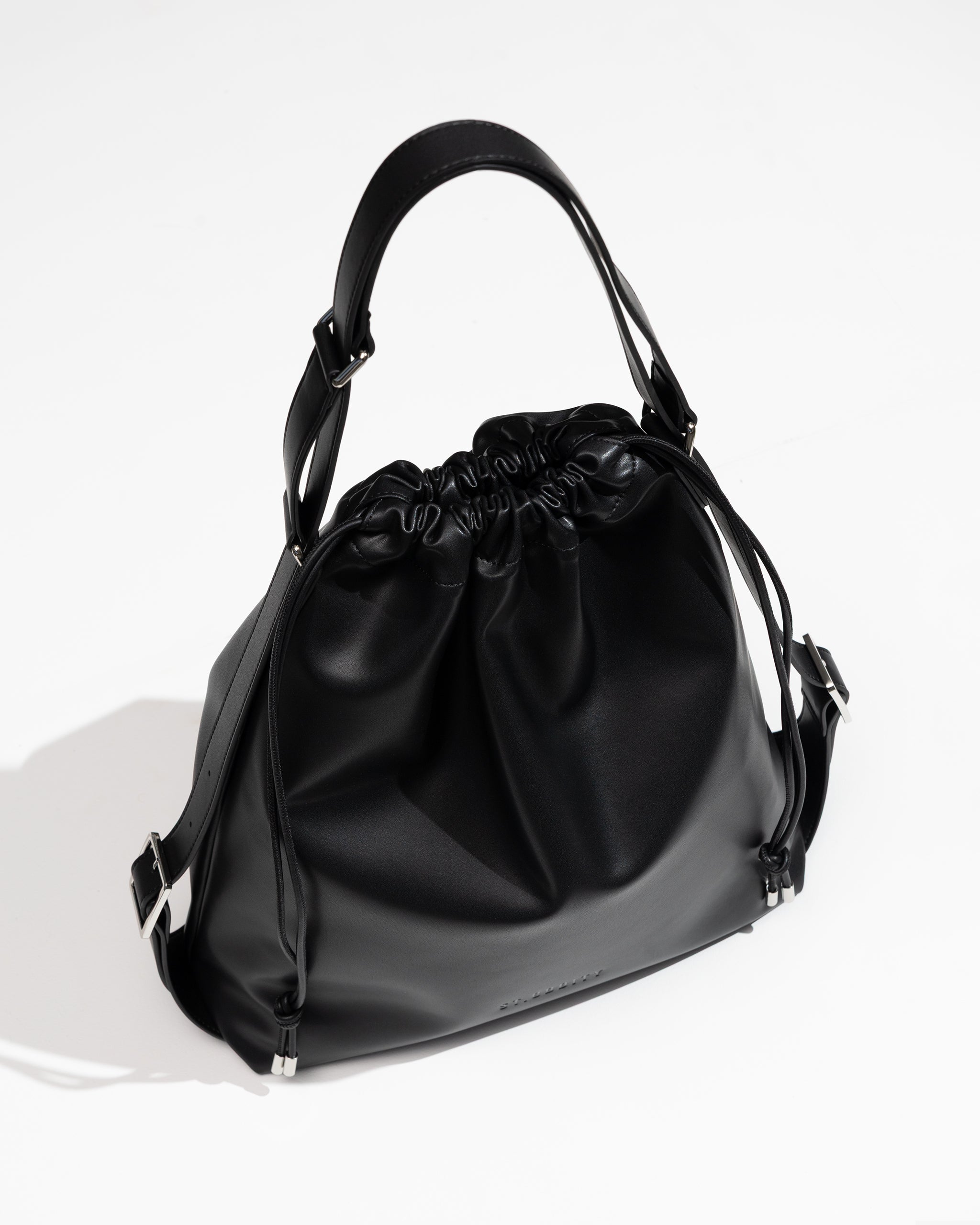 Black handbag with drawstring on a white background