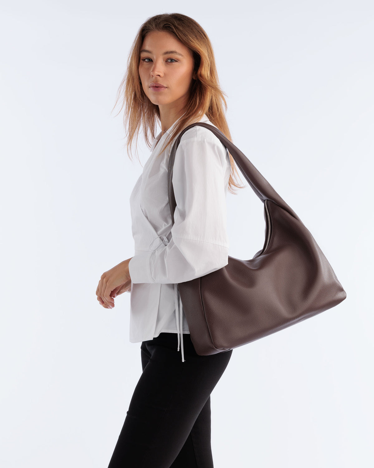 Model carrying the Hobo Bag in Brown