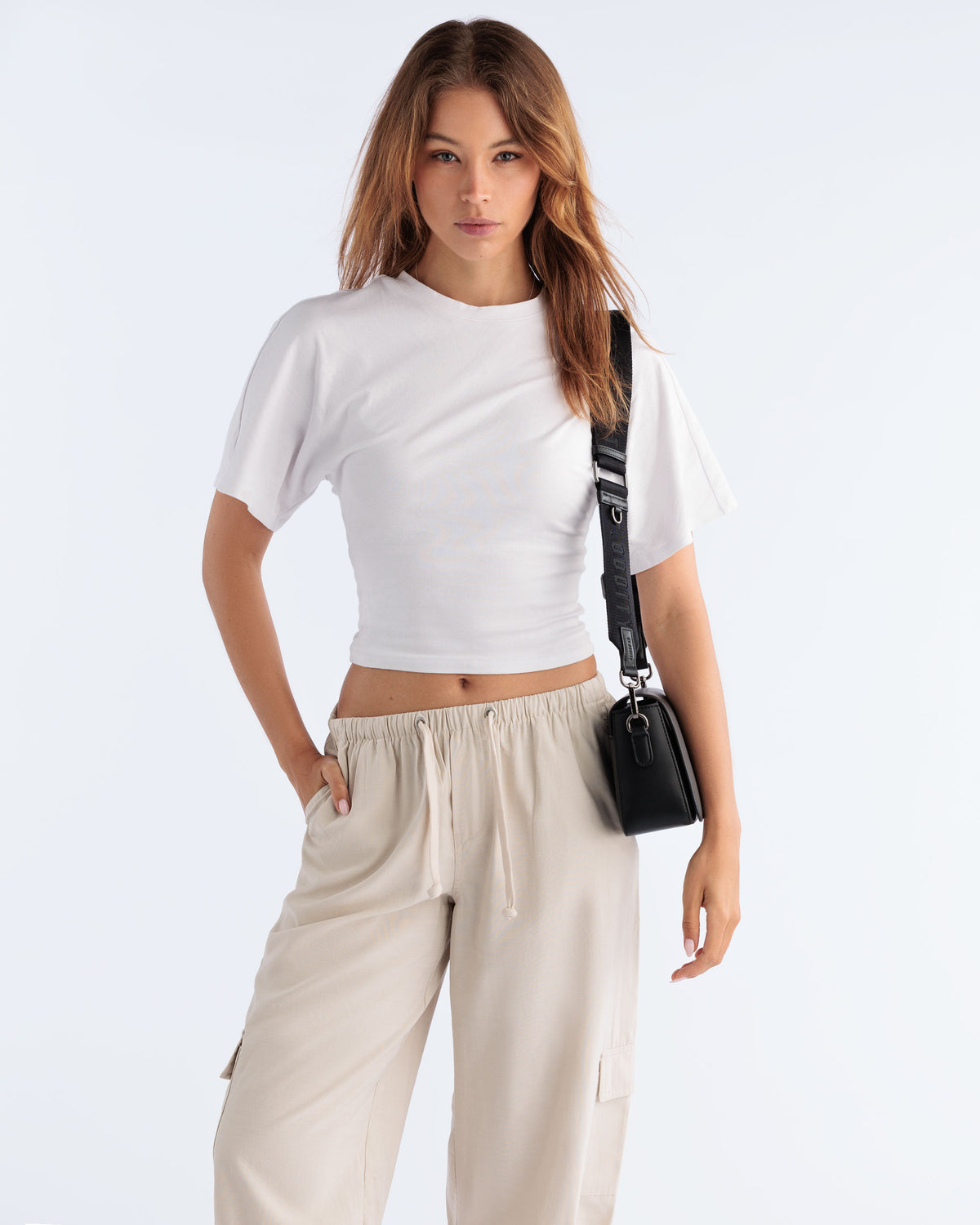 Model wearing the Street Crossbody Bag in Black with gunmetal hardware