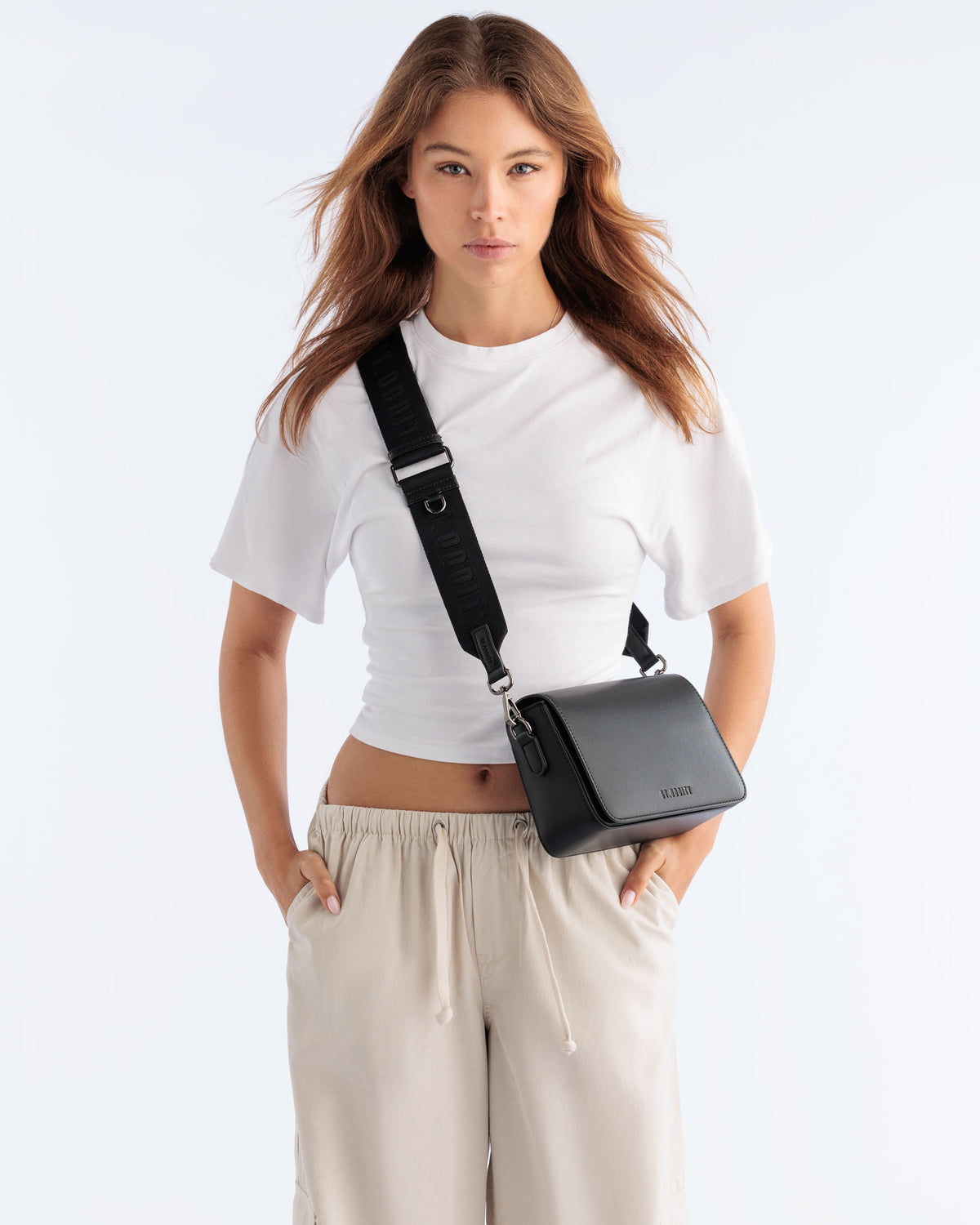 Model wearing the Street Crossbody Bag in Black with gunmetal hardware
